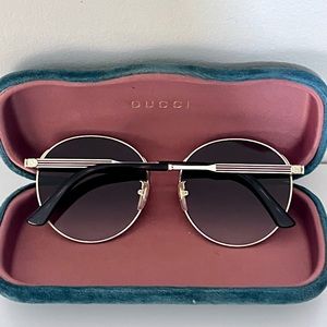 Gucci gold and brown round sunglasses with classic Gucci details on arm